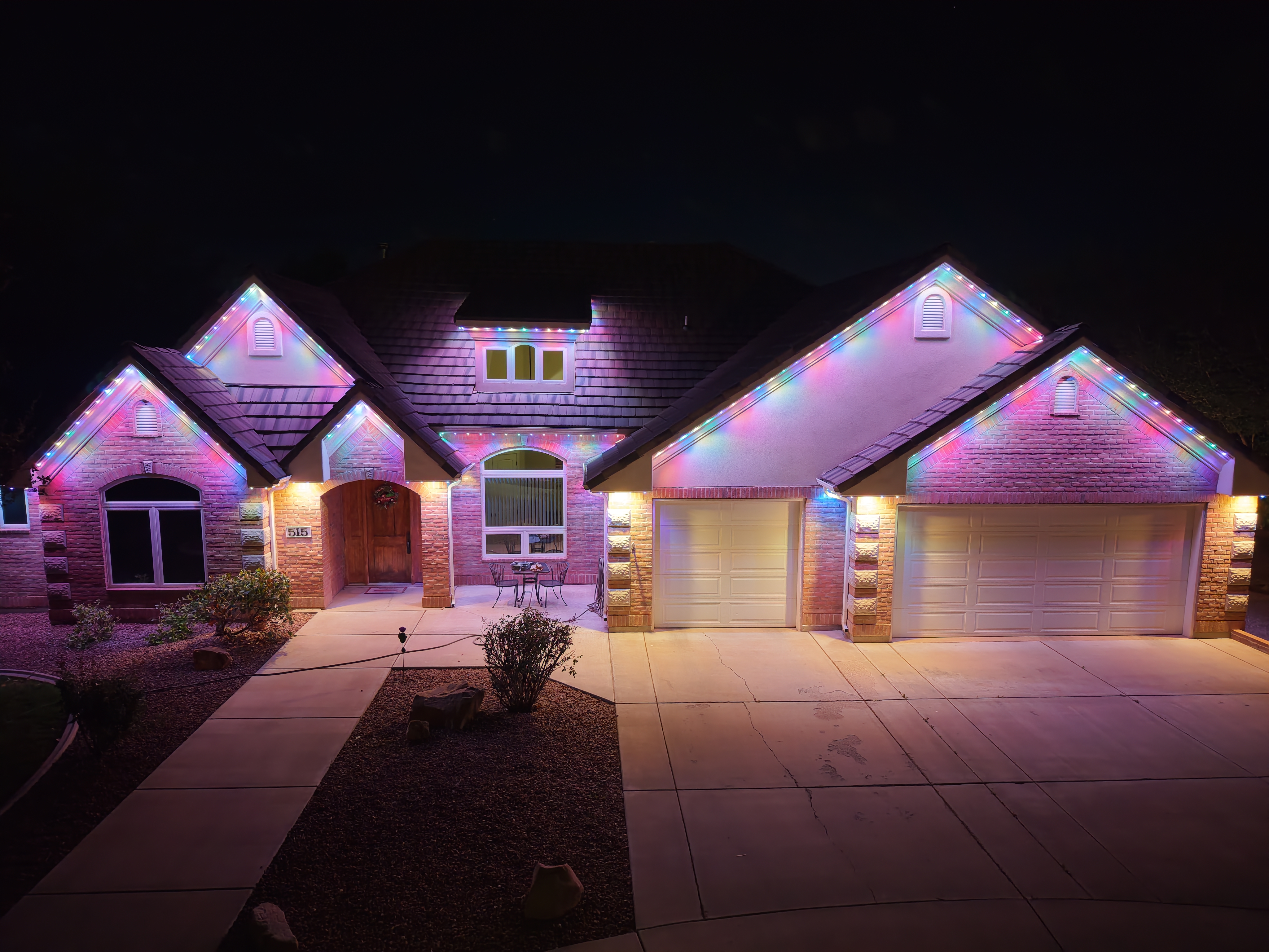 Colorful outdoor lighting installation on residential house
